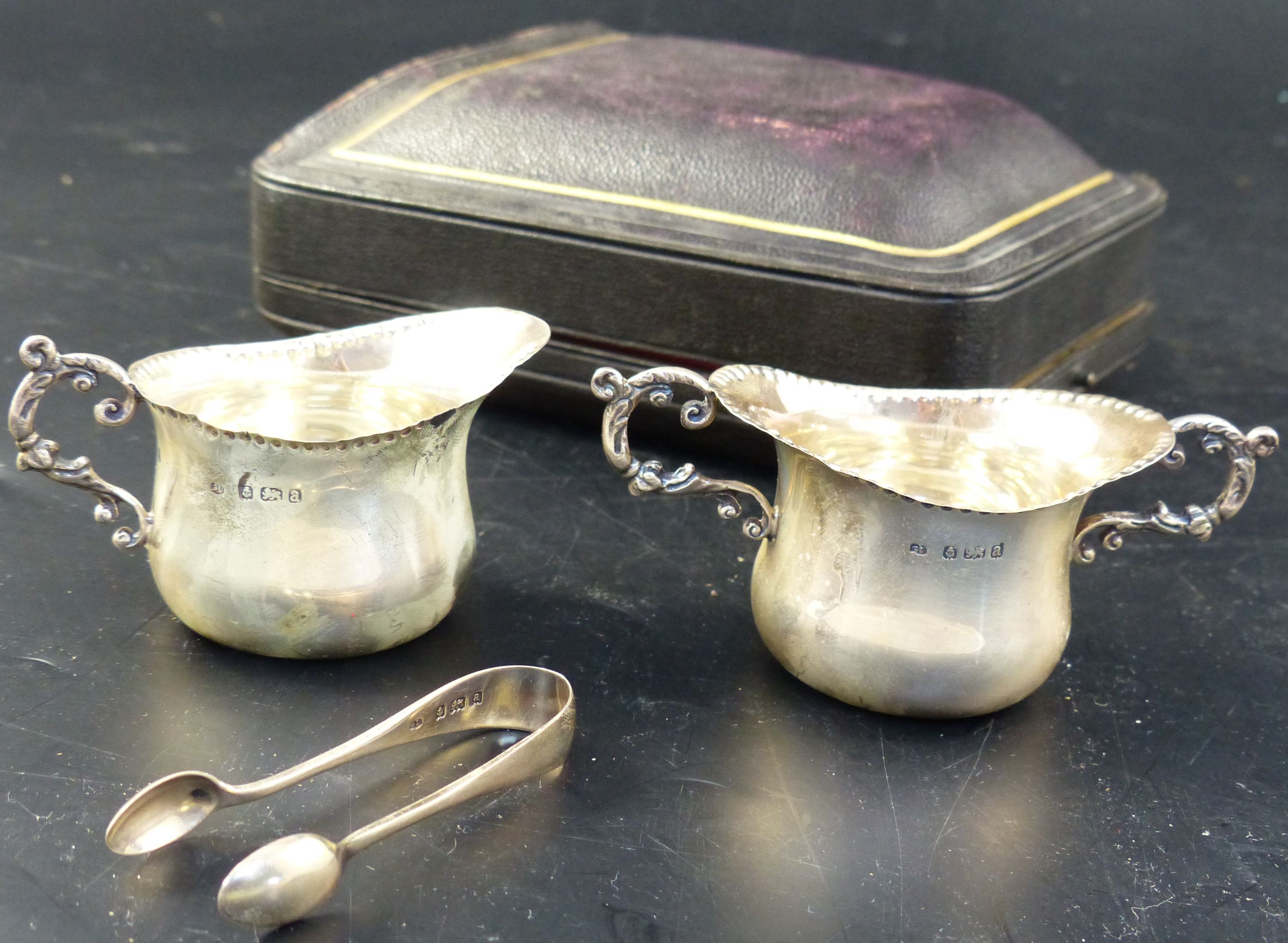 A late Victorian cased silver three piece cream and sugar set, 84 grams.